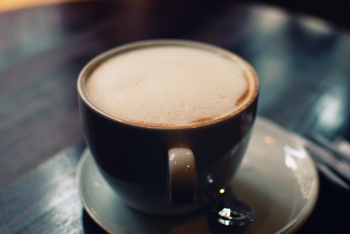 Cup of coffee with foam on a saucer