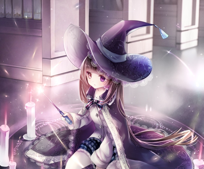 Girl in witch costume with magic wand