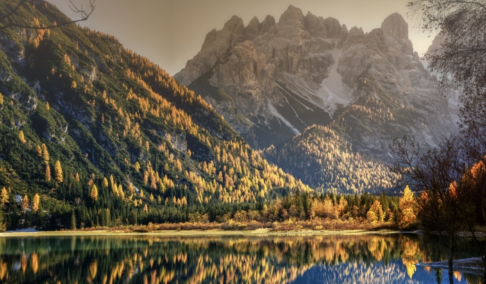 Mountain lake with autumn trees and rocky peaks