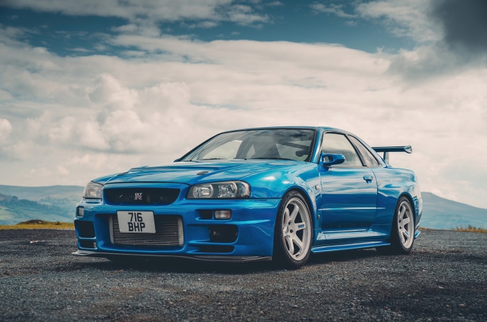 Blue Nissan Skyline R34 GT-R parked outdoors