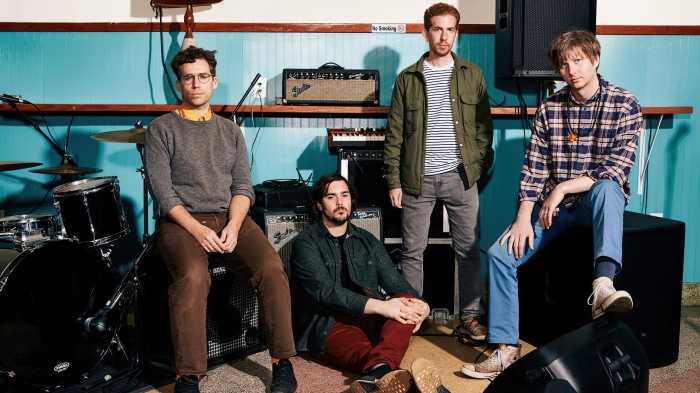 Parquet Courts band members in a room with instruments