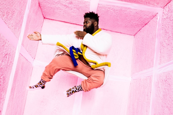 Man in pink room doing karate