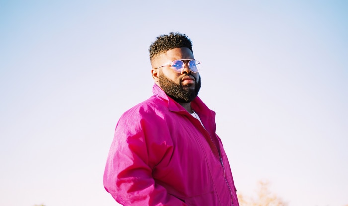 Man in pink jacket and glasses