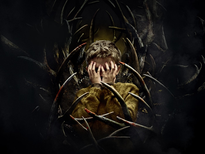 Boy hiding from antlers 4K