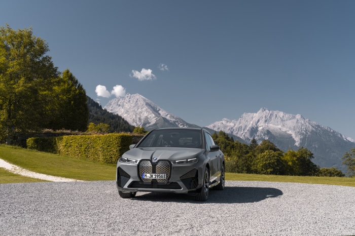 BMW iX M60 electric SUV in a mountain landscape
