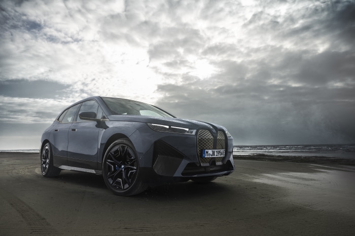 BMW iX M60 electric SUV on a beach