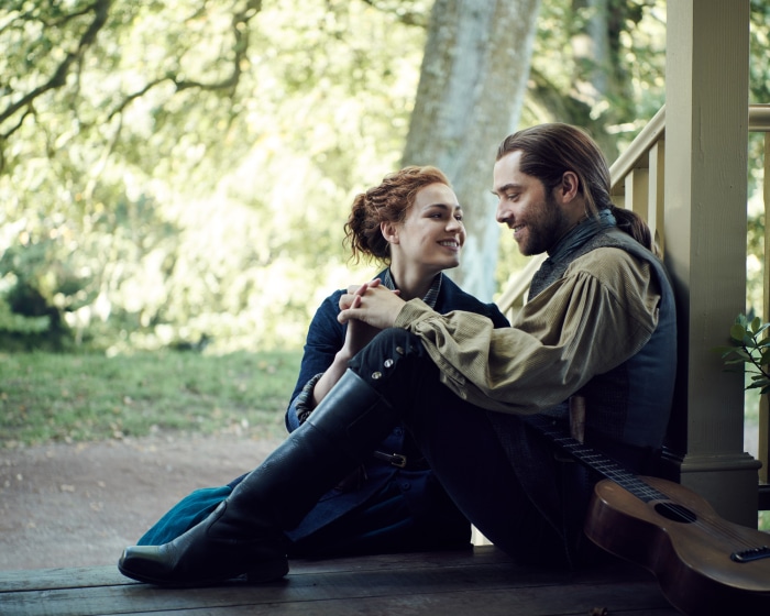Couple from Outlander sitting on a porch