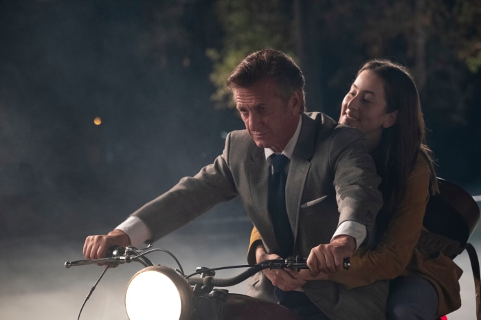 Sean Penn and Alana Haim on a motorcycle