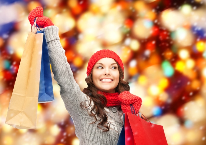 Woman in winter clothes holding shopping bags