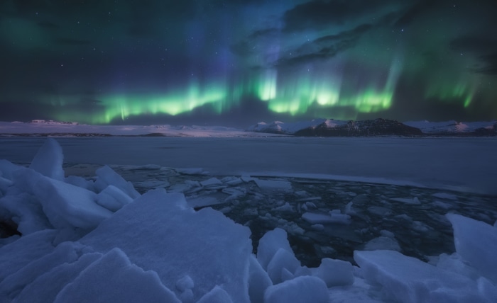 Aurora Borealis over a frozen landscape in Norway