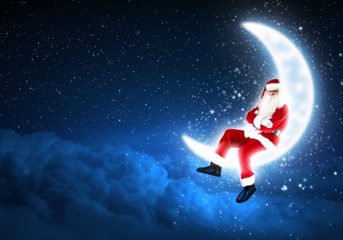 Santa Claus sitting on a crescent moon