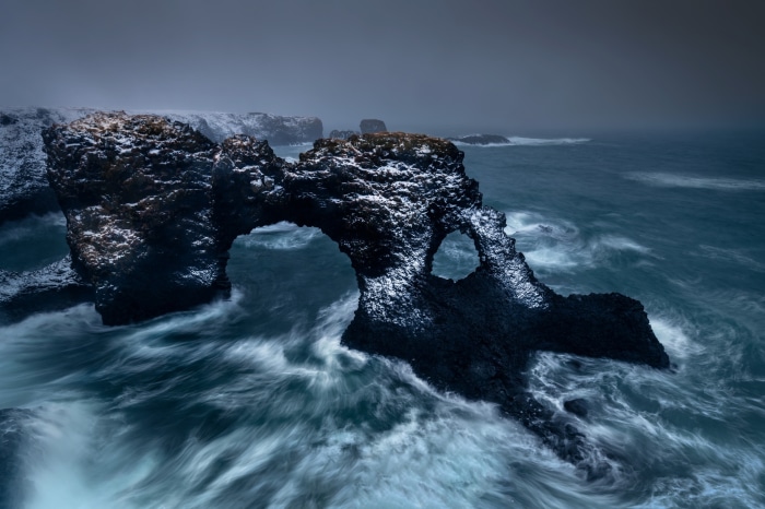 Natural rock arch with ocean waves