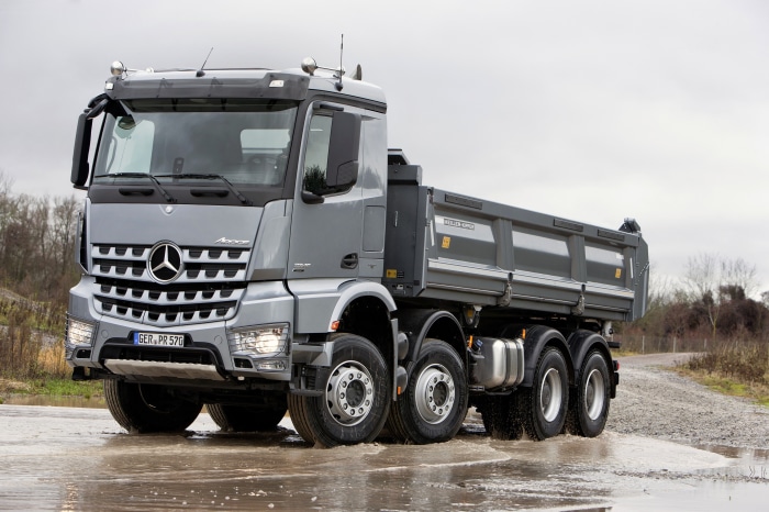 Mercedes-Benz Arocs dump truck driving through water