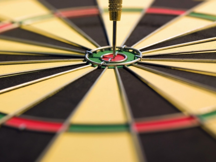 Dartboard with a dart in the bullseye