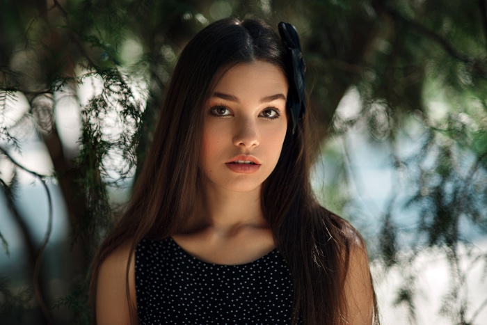 Brunette girl with a black bow in her hair
