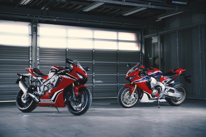Two Honda CBR1000RR motorcycles in a garage