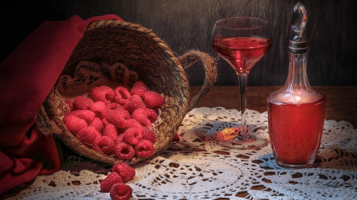 Still life with raspberries, wine, and a decanter