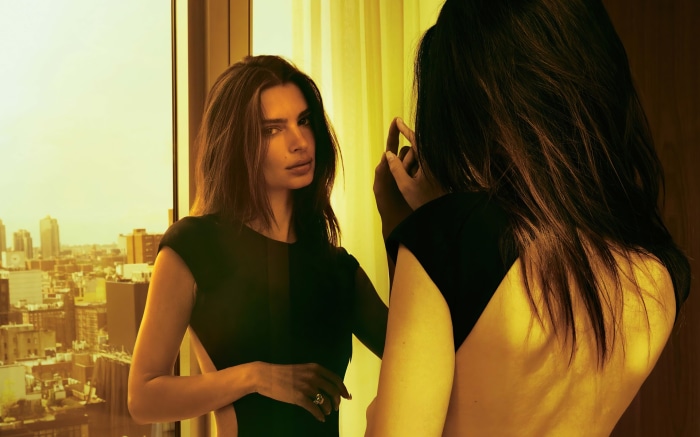 Emily Ratajkowski in black dress reflected in mirror