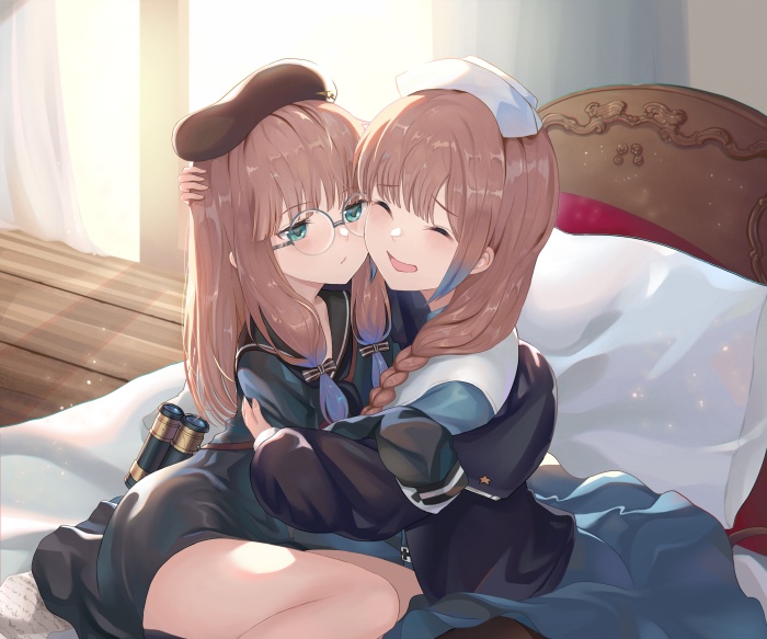 Two girls hugging, one wearing a captain's hat