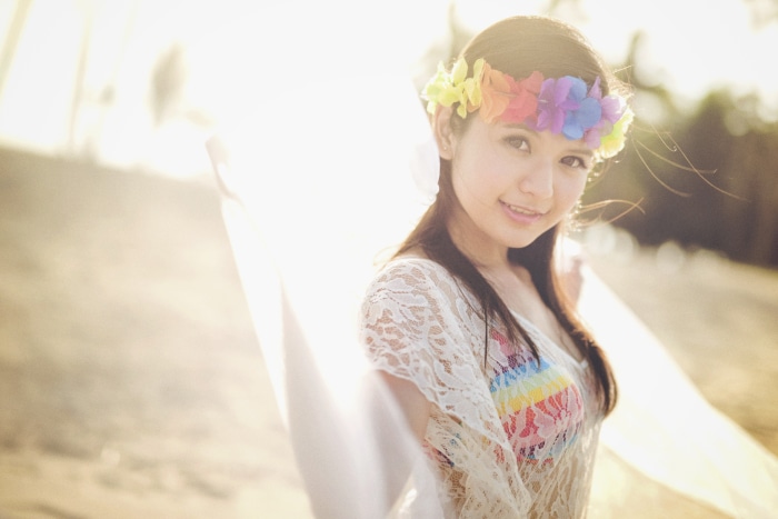 Young Asian woman with flower crown on beach