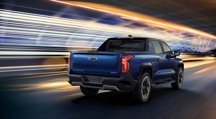 Blue Chevrolet Silverado EV RST Crew Cab driving fast
