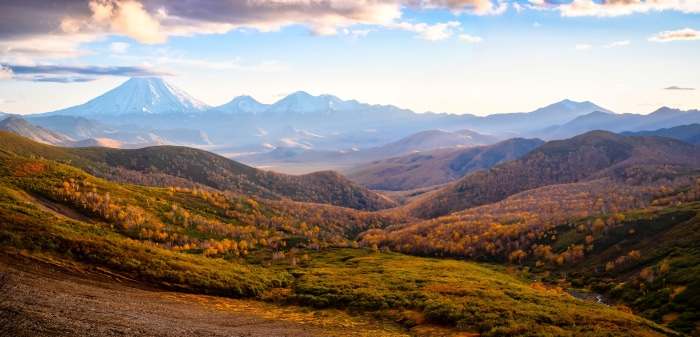 Autumn mountain landscape with snow-capped volcanoes