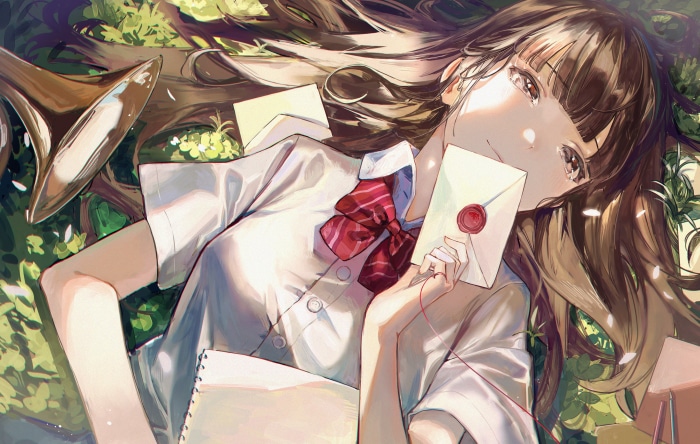 Girl in school uniform lying down with letters