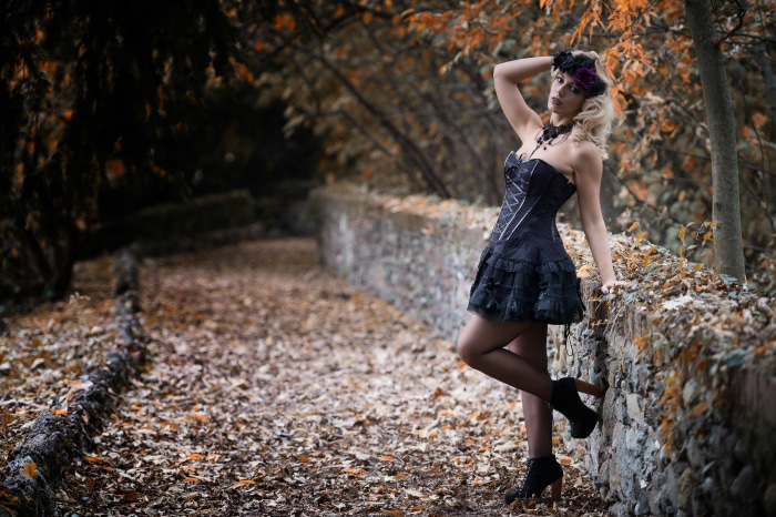 Model in Elegant Black Dress on Autumn Path