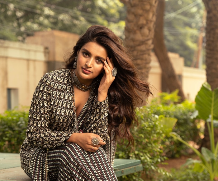 Indian woman with long brown hair wearing traditional jewelry