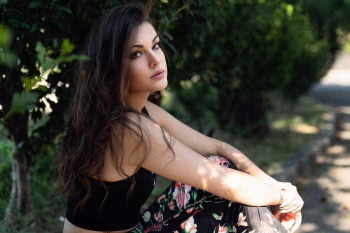 Brunette woman sitting outdoors
