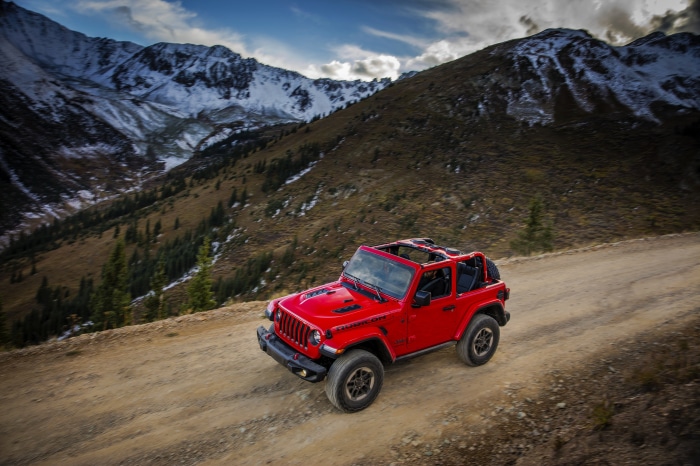 Red Jeep Wrangler Rubicon on a mountain road