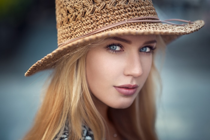 Woman with blue eyes wearing a straw hat