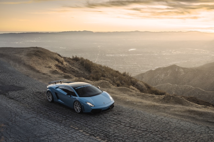 Blue Lamborghini Gallardo on a mountain road
