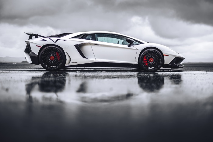 White Lamborghini Aventador SV on wet asphalt