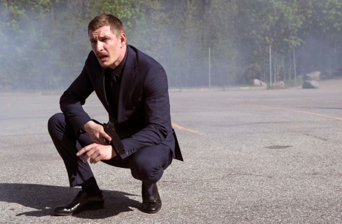 Man in Suit Holding Gun in Smoke