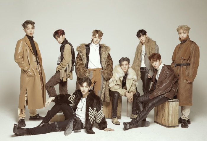 ATEEZ members posing in stylish fall fashion
