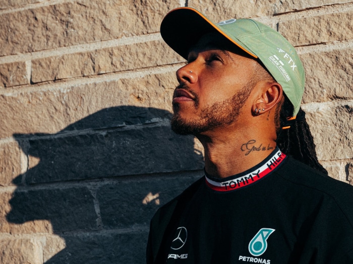 Lewis Hamilton wearing a Tommy Hilfiger shirt and cap