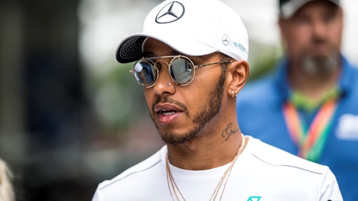 Lewis Hamilton wearing sunglasses and a Mercedes-Benz cap