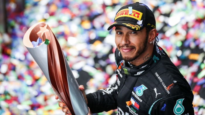 Lewis Hamilton celebrating F1 victory with trophy