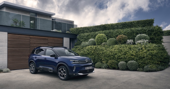 Blue Citroen C5 Aircross SUV parked in front of a modern house