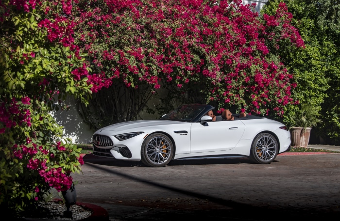 White Mercedes-AMG SL Cabriolet parked near pink flowers