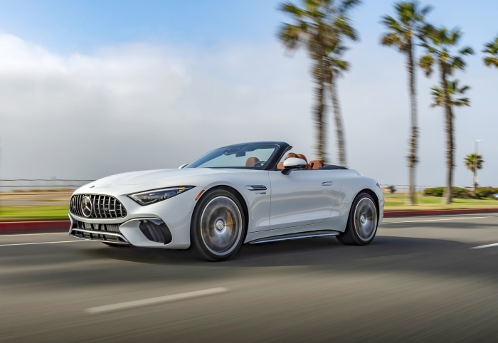 White Mercedes-AMG SL Cabriolet driving on a road