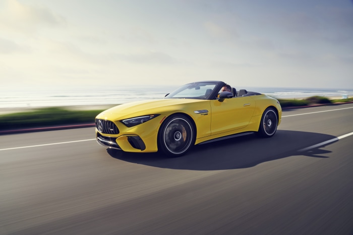 Yellow Mercedes-AMG SL Cabriolet driving on coastal road