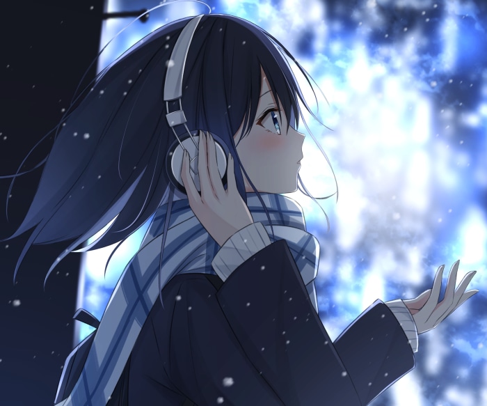Girl with headphones in the snow