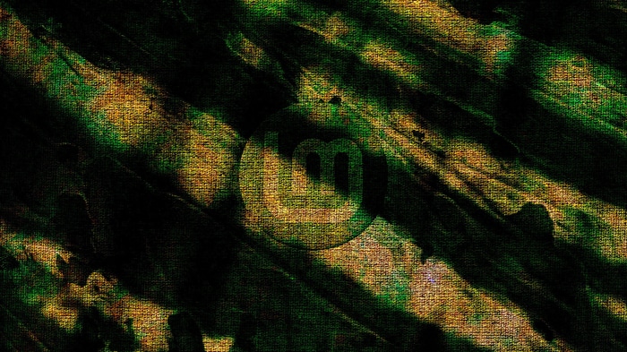 Linux Mint logo on abstract green and gold background