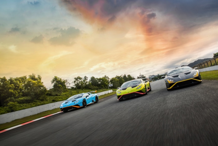 Three Lamborghini Huracán STO cars on a racetrack