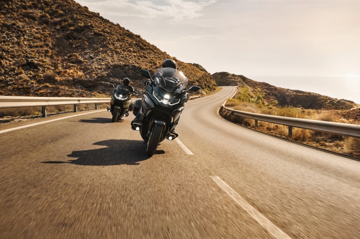 Two BMW K 1600 B motorcycles on a coastal road