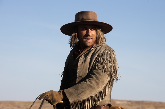 Man in cowboy hat and fringed jacket