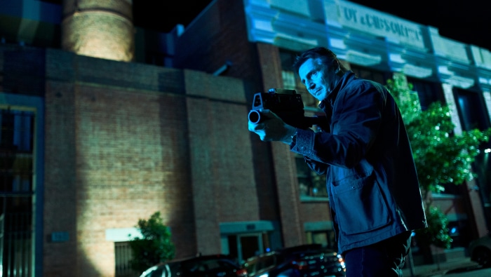 Liam Neeson with a gun at night