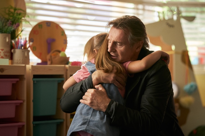 Liam Neeson hugging a young girl